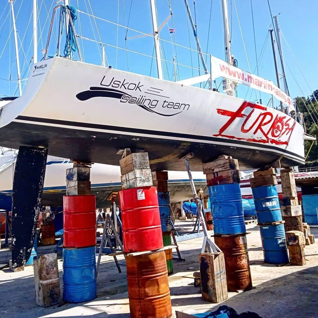 Sailboat from Marlin Sailing Academy in Zadar, Croatia, elevated for maintenance, showcasing expertise in sailing school programs, skipper courses, beginner and advanced sailing courses, private day trips, sailing team buildings, and daily sailing tours exploring the Zadar archipelago, perfect for Zadar day trips, boat tours, and excursions.