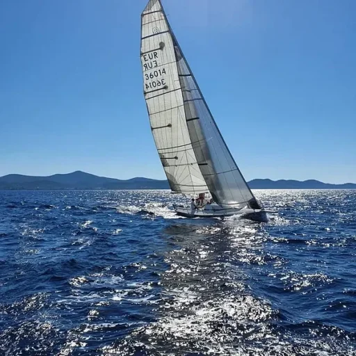 A sailboat gliding through the open ocean, ideal for sailing courses and tours in Zadar, Croatia. Perfect for all skill levels.