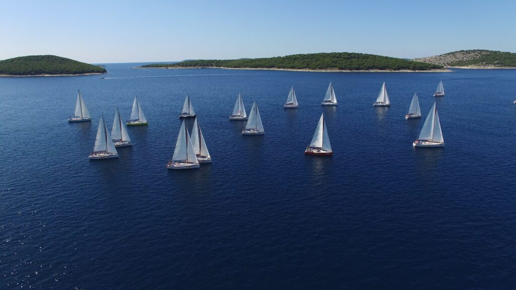 Sailboats navigating the open sea, ideal for regatt sailing course and tours in Zadar, Croatia. Perfect for all skill levels.