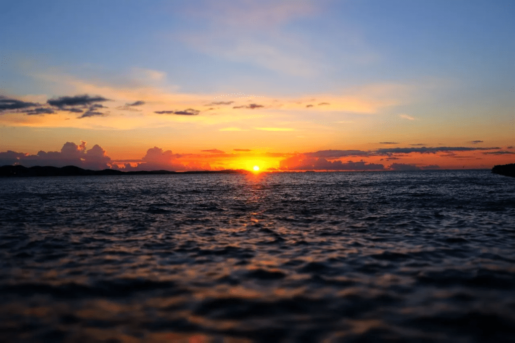 A breathtaking Caribbean sunset over tranquil waters, perfect for sailing tours and courses in Zadar, Croatia.