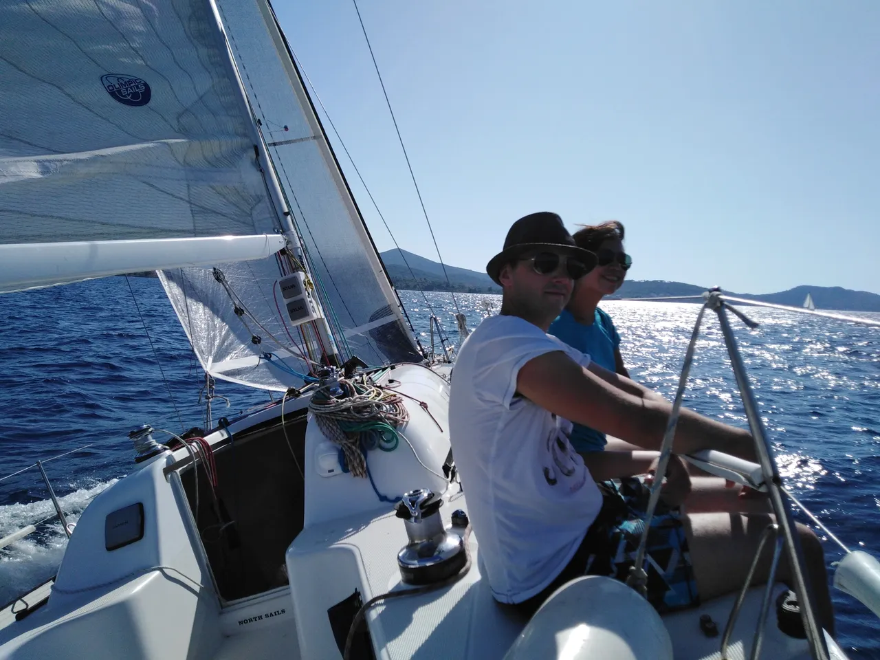 Two people sailing on a boat in the Zadar archipelago, Croatia, during a sailing course and half day sailing tour.