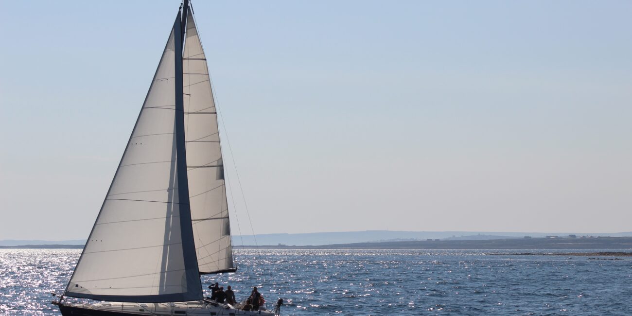 A sailboat gliding across the water, symbolizing adventure and learning at a sailing academy and monohull sailing course in Zadar, Croatia.